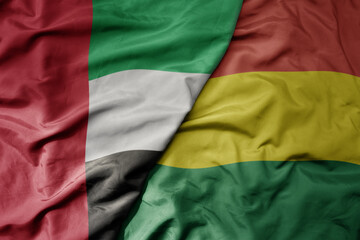 big waving realistic national colorful flag of united arab emirates and national flag of bolivia .