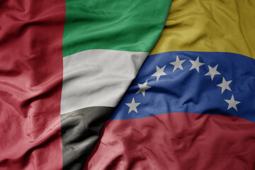 big waving realistic national colorful flag of united arab emirates and national flag of venezuela .