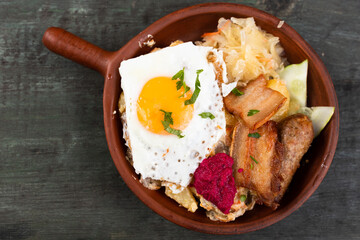 Breakfast of scrambled eggs with fried bacon and potatoes