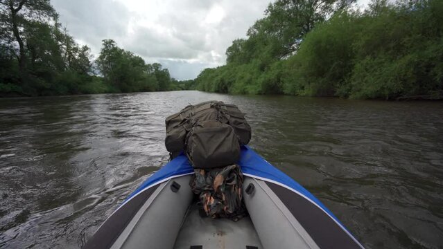 River kayaking POV with large camping rucksack