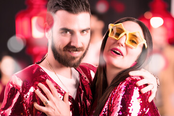 Couple, united, disregards opinions, revels in excess