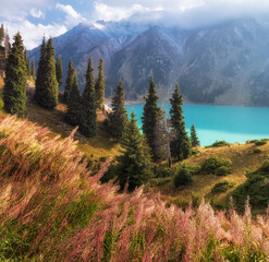 Big Almaty Lake in Tien Shan mountains of Kazakhstan. Panorama of Beautiful mountain landscape on a fall evening with white first fall snow