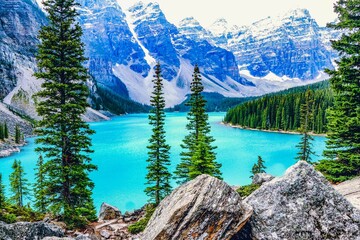 Scenic view of the tranquil turquoise Moraine Lake surrounded by towering mountains