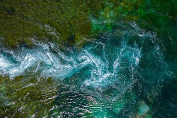 Aerial view of the emerald sea with waves