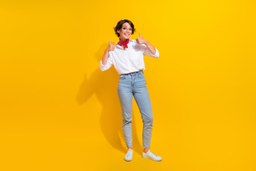 Full length photo of satisfied lovely girl entrepreneur wear stylish outfit hands thumbs up cool offer isolated on yellow color background