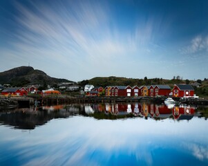 Fototapeta premium Stunning scene in the Lofoten Islands of Norway, showing traditional red-painted houses