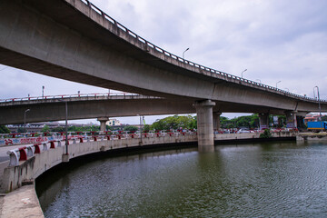 Non-stop speedway  Kuril Flyover with cloudy sky and lake in Dhaka Bangladesh