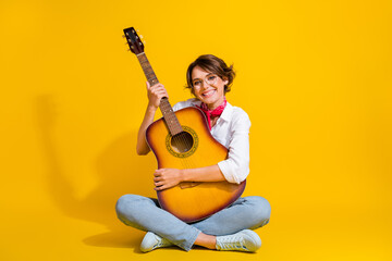 Photo of cheerful lovely girl wear trendy clothes sitting floor hold guitar instrument having fun...