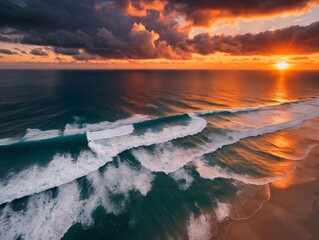 Naklejka premium The Sun Sets Over The Ocean As Waves Crash On The Beach