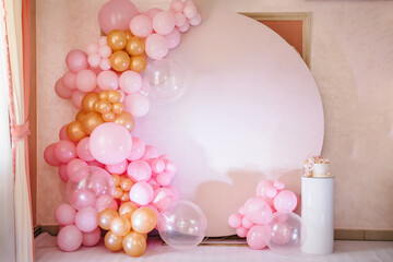 Arch decorated with pink, white and golden balloons. Trendy baptism cake for girl. Delicious...