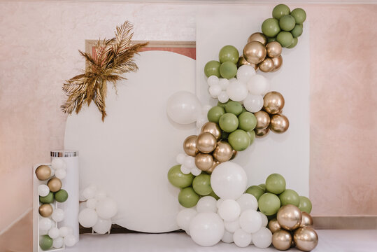 Arch on background balloons, party decor. Trendy autumn decor. Photo wall decoration space or place with white, golden, green balloons. Celebration baptism concept. Birthday party. Wedding reception.