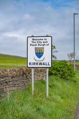 Kirkwall Scotland entrance Sign next to the road, vertical shot