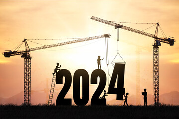 Silhouette engineers working on a construction site To prepare to welcome the new year , cranes and...