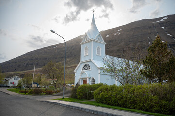Fototapeta na wymiar Blue wooden Church at Seydisfjordur, Iceland, sun beam