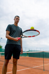 young tennis player coach hitting the ball with a racket on the tennis court preparing for the competition sports lifestyle
