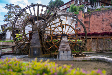 The water wheel in Old Town of Lijiang in Yunnan, China. It is part of UNESCO World Heritage Site -...