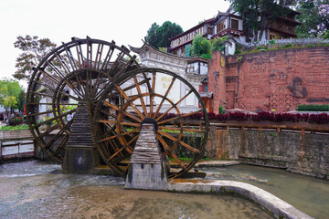 The water wheel in Old Town of Lijiang in Yunnan, China. It is part of UNESCO World Heritage Site -...