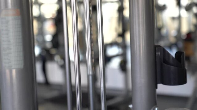 Barbell in gym, shot of exercise equipment in a gym, modern fitness equipment, Weight in the gym. Weight training plate, Weights next to barbell in a gym 