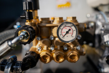 Fototapeta na wymiar Water pressure gauge close up with valves and engine