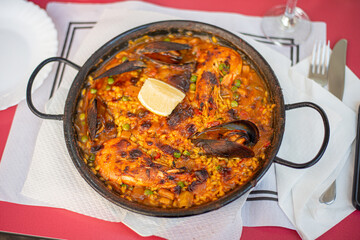juicy paella with seafood king prawn muscles and fish on a hot pan