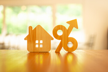  Percentage and house sign symbol icon wooden on wood table. Concepts of home interest, real...