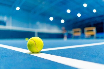 a small bright ball lies on the tennis court professional sport training hobby game