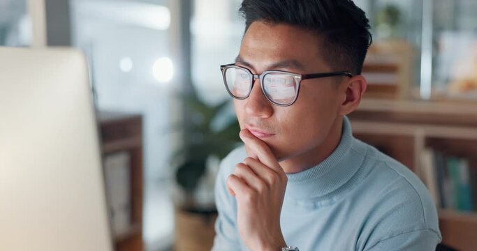 Man at computer, glasses and reflection, thinking and reading email, review or article at digital agency. Internet, research and Asian businessman at tech startup with report, networking or feedback.