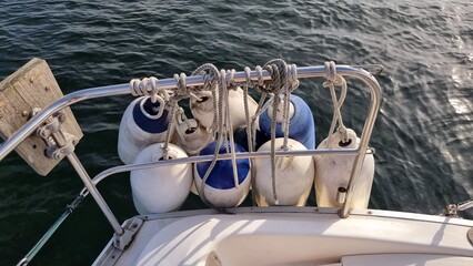 Fenders tied to rail of sailing boat