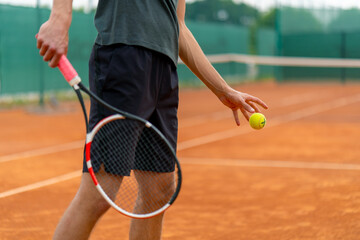 young professional player coach on outdoor tennis court practices strokes with racket and tennis...
