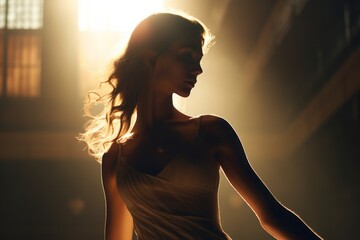 Silhouette of a dancer, illuminated by the golden sun, creating a mesmerizing contrast.