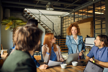 Young and diverse group of designers having a meeting in an office while working in a startup company