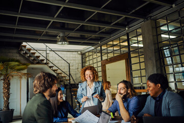 Young and diverse group of designers having a meeting in an office while working in a startup company