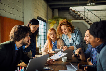 Young and diverse group of designers having a meeting in an office while working in a startup company
