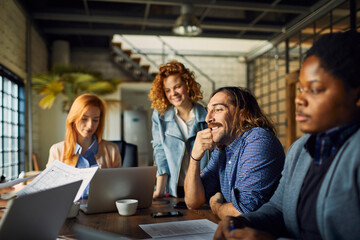 Young and diverse group of designers having a meeting in an office while working in a startup company