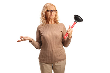 Confused mature woman holding a toiler plunger