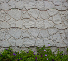 Photo of a section of a concrete fence with an abstract decorative pattern. Photo of a fragment of...