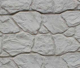 Photo of a section of a concrete fence with an abstract decorative pattern. Photo of a fragment of...