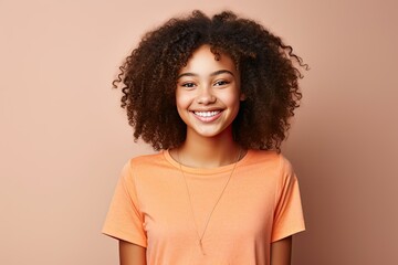 portrait beautiful afro american teenager girl dressed in t-shirt and smiling, light background - obrazy, fototapety, plakaty