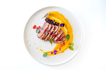 Duck fillet with sweet potato puree and lingonberries isolated