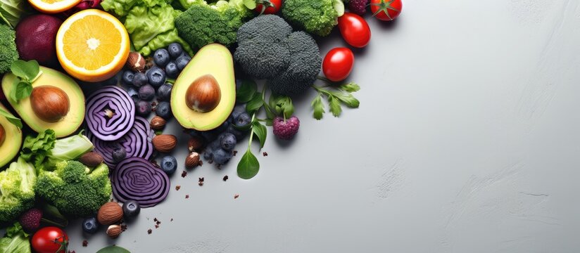Top view of fresh healthy vegan and vegetarian food on a grey background conveying the concept of diet detox and clean eating Panoramic banner with copy space