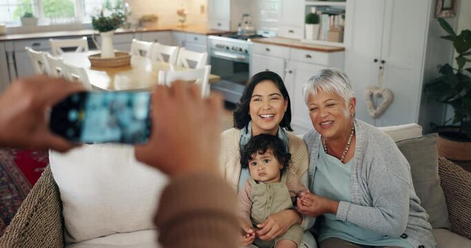 Phone screen, hands and picture of family in living room with smile, kids and grandparent on sofa. Social media, photo and mother with a baby and grandmother happy in a home together with love
