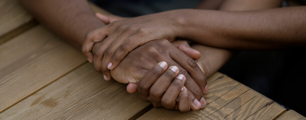black couple in love hold each other hand, symbol of support trust and empathy