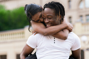 black afro american boy and girl hug each other outdoors, happy emotions and smile