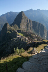 Panorama of Machupicchu with view of the mountains and archeological site, along with a stone staircase to the ruins, in Peru, Sacred Valley. 