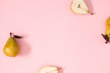 Yellow pears pattern minimalism. Close up of pear on pastel pink background. Autumn fruit concept...