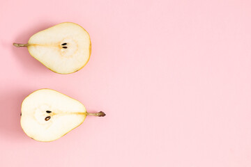 Yellow pears pattern minimalism. Close up of pear on pastel pink background. Autumn fruit concept from ripe juicy pears. Flat lay, top view