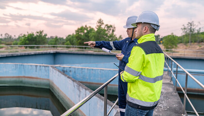 Environmental engineers work at wastewater treatment plants,Water supply engineering working at Water recycling plant for reuse,Technicians and engineers discuss work together.