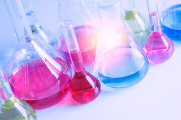 Purple and blue color glass flask in white light background. Concept banner research study of...