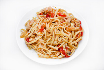 Korean Udon noodles with meat on a white plate. Delicious spicy meat breakfast.
