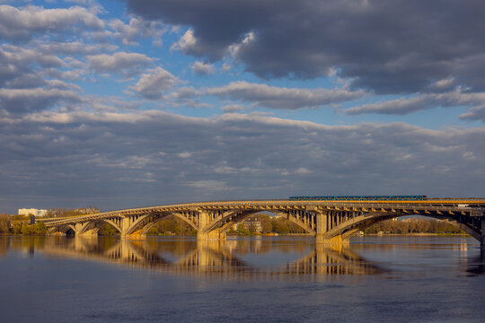 Metro bridge and the Dnipro river at sunset time in Kyiv, Ukraine